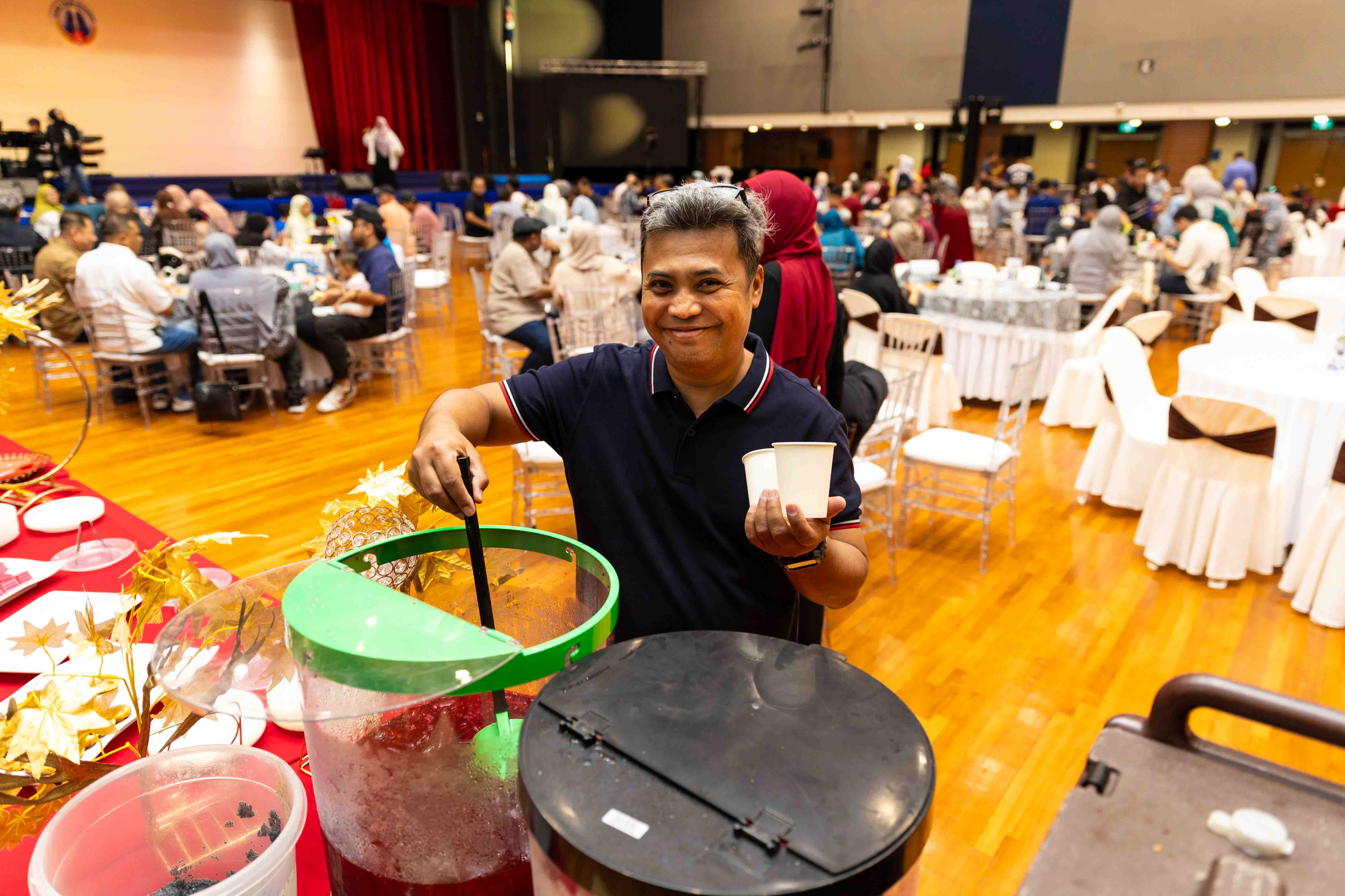 An attendee helps himself to refreshments at the drink station.